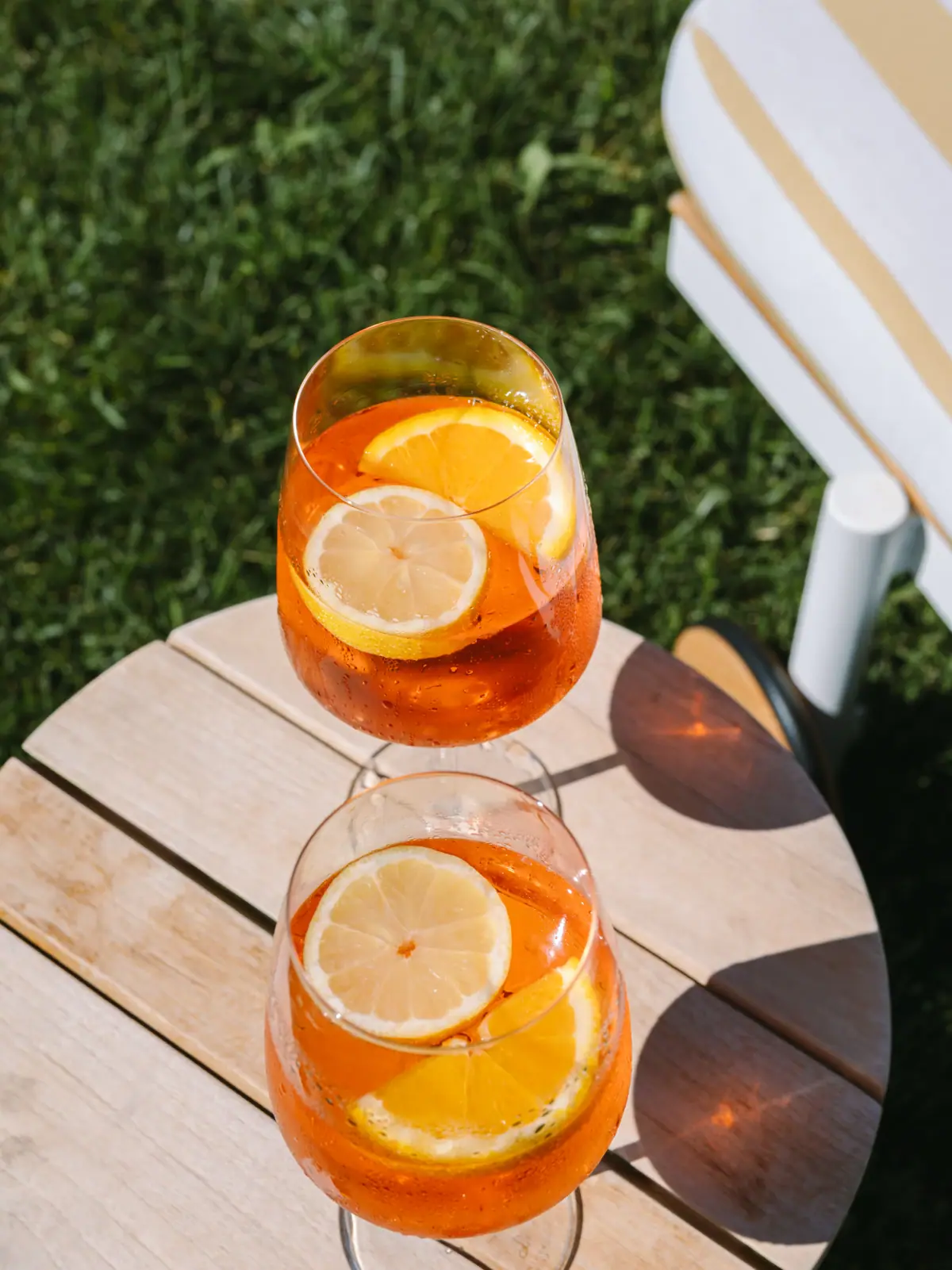 Aperol Spritz Zwei Gläser mit Aperol Spritz und Zitronenscheiben auf einem Tisch.