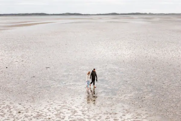 Wattenmeer Ein Paar geht durchs Watt spazieren.