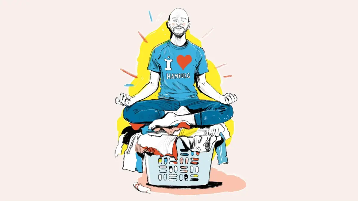 Yogi auf Wäschekorb Ein Mann sitzt auf einem Wäschekorb, während Kleidung in der Luft schwebt.