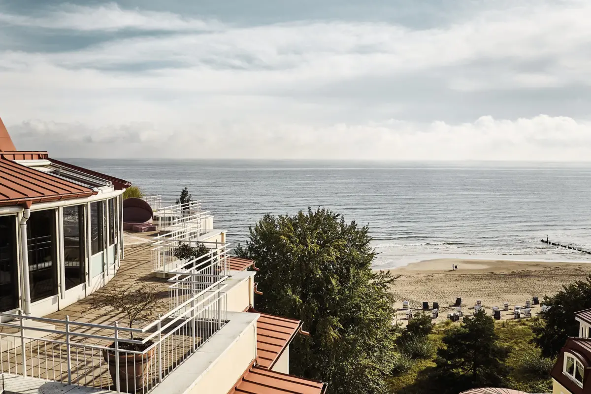 aja Strandhotel Bansin Strand mit einem Gebäude und einem Gewässer im Hintergrund